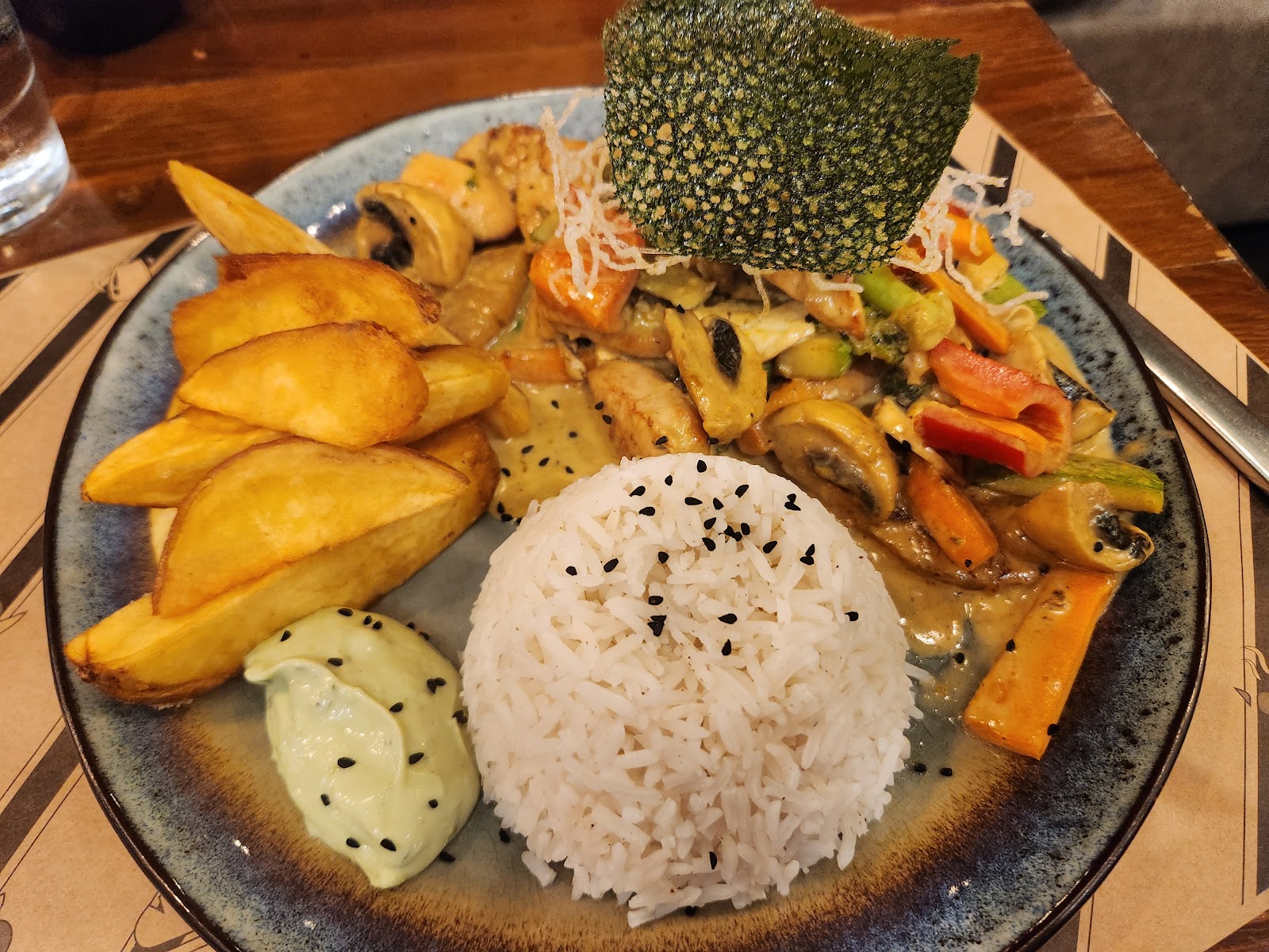 A rice and vegetable plate with potato wedges at Donvitto